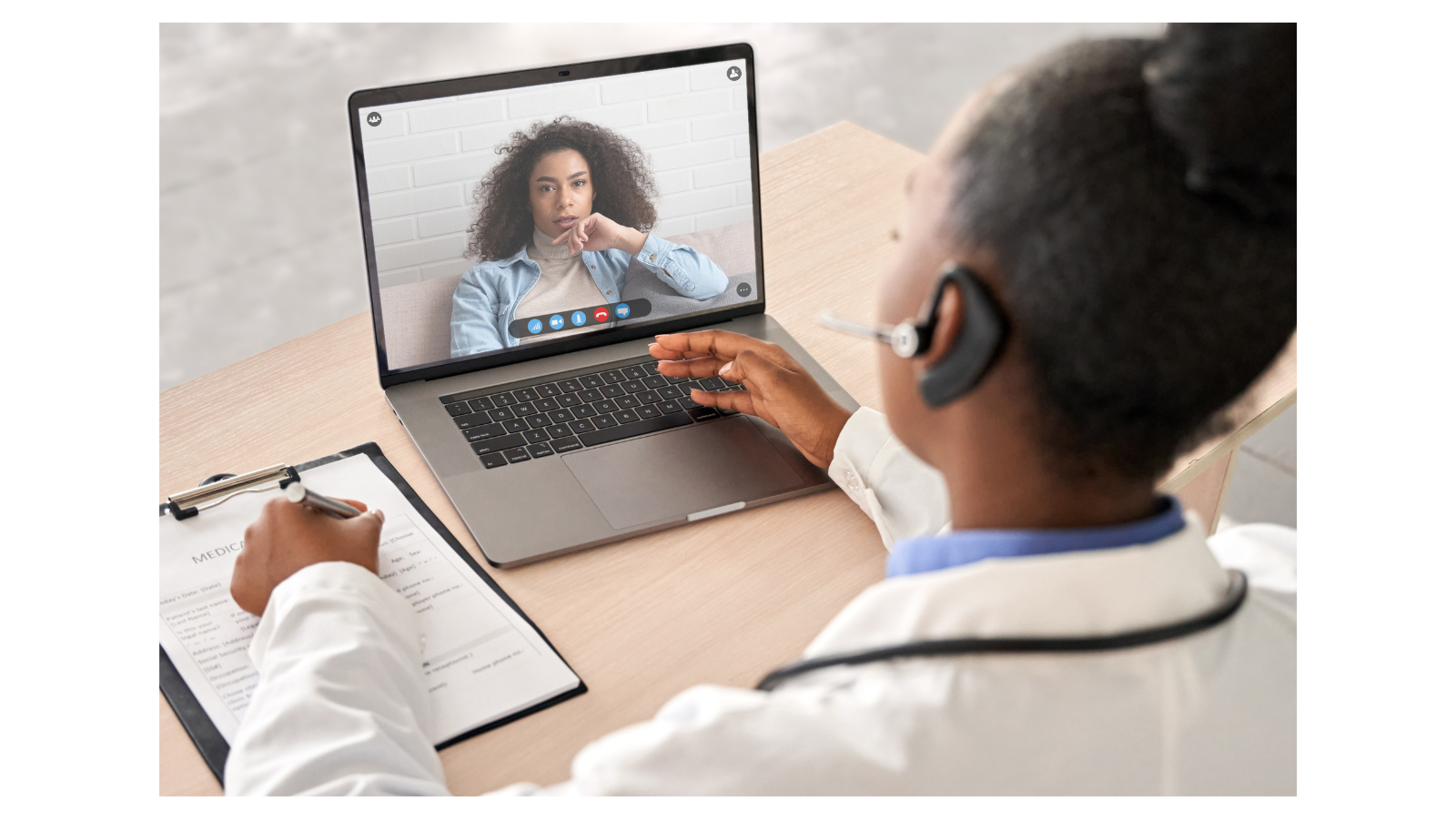 A clinician providing telehealth services on a laptop
