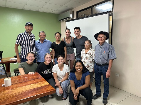 A group of UMB students pose with Costa Ricans inside a room.